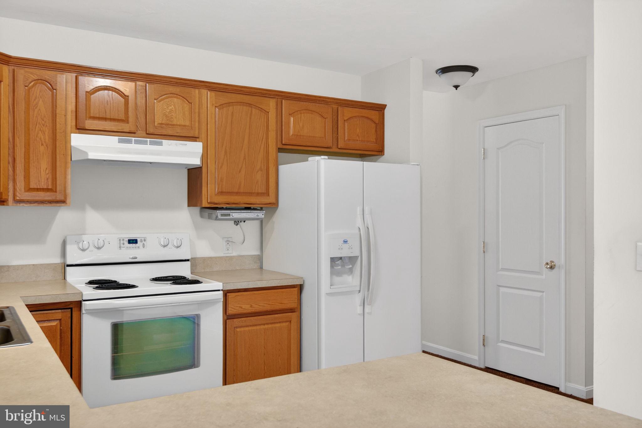 213 Maple Drive Hanover, PA 17331 - Photo 10 of 24 a kitchen with stainless steel appliances granite countertop a stove a sink and a refrigerator with cabinets