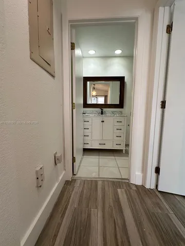 a bathroom with a granite countertop sink toilet a mirror a vanity and shower