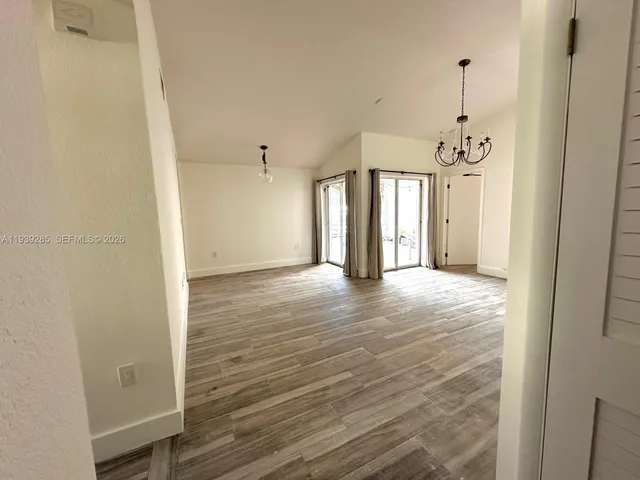 a kitchen with granite countertop a refrigerator stove and oven