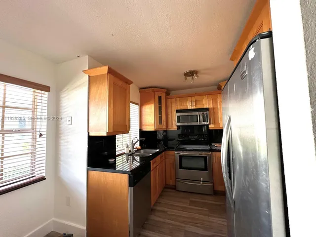 a kitchen with a refrigerator and cabinets