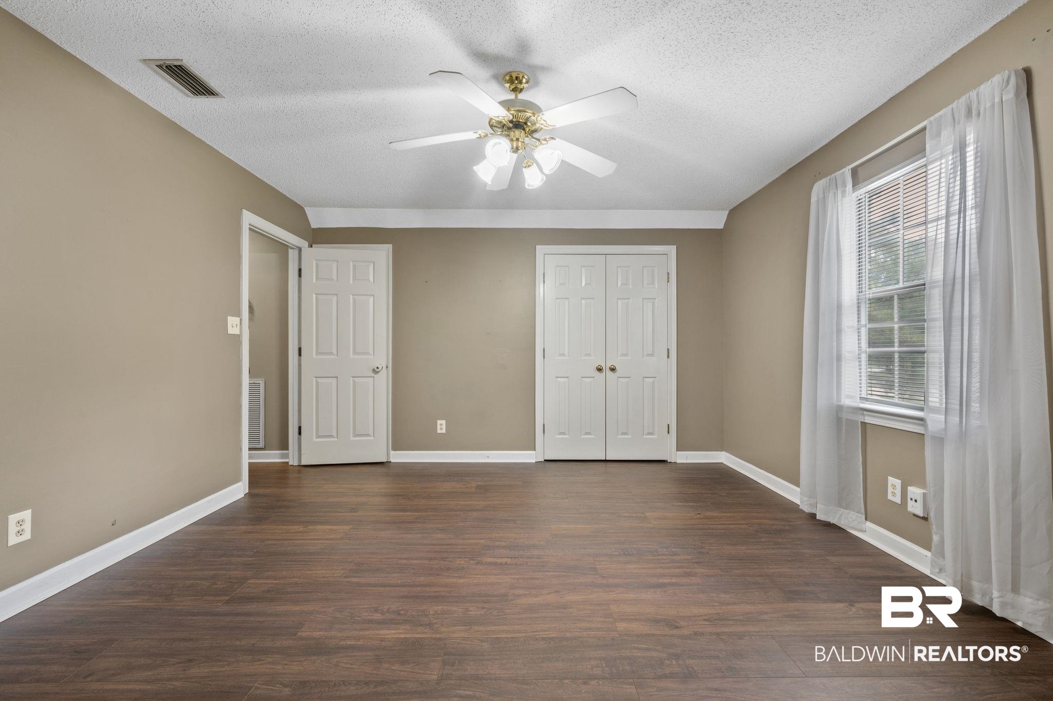 100 Montclair Loop Daphne, AL 36526 - Photo 34 of 39 Unfurnished bedroom featuring dark hardwood / wood-style flooring, a textured ceiling, and ceiling fan