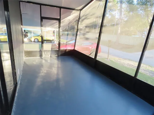 a view of empty room with window and fireplace