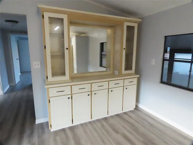 a view of kitchen with refrigerator stove and wooden floor