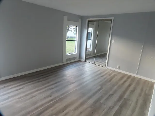 a bathroom with a granite countertop sink toilet and mirror