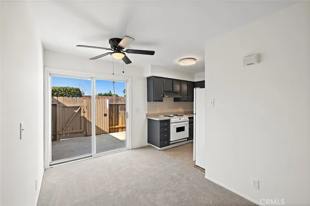 a view of a kitchen with a sink and a refrigerator