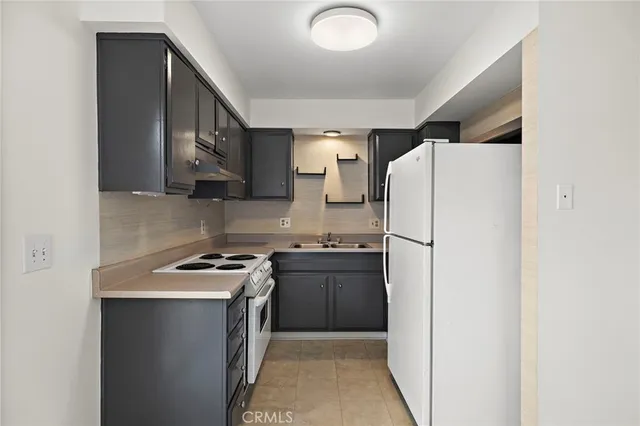 a kitchen with stainless steel appliances a refrigerator a stove and a sink