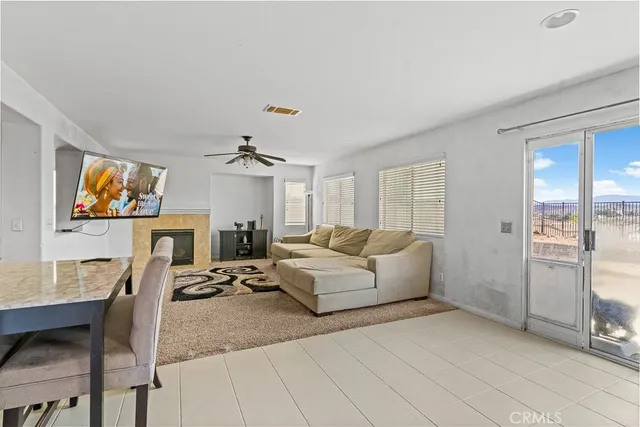a living room with furniture a chandelier and a flat screen tv
