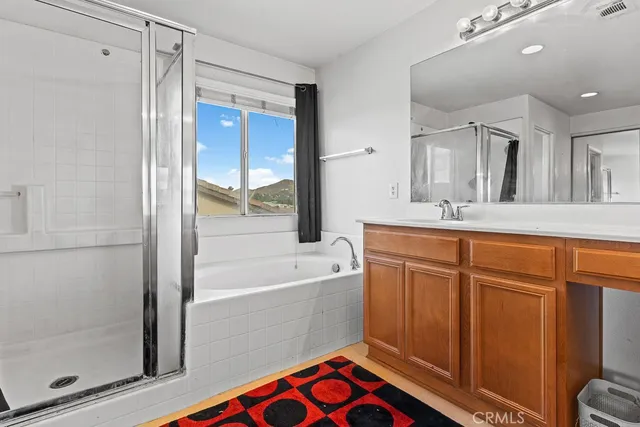 a bathroom with a bathtub sink and mirror