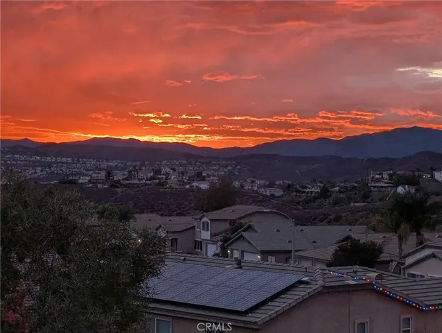 a view of a terrace with a table and chairs under an umbrella