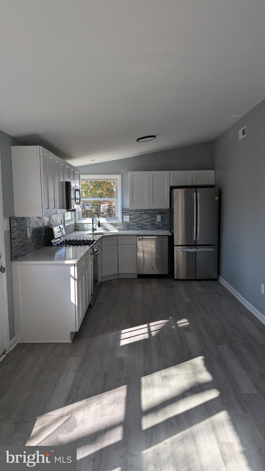 728 Aston Martin Drive Lindenwold, NJ 08021 - Photo 2 of 12 a kitchen with stainless steel appliances granite countertop a stove a sink dishwasher and a refrigerator