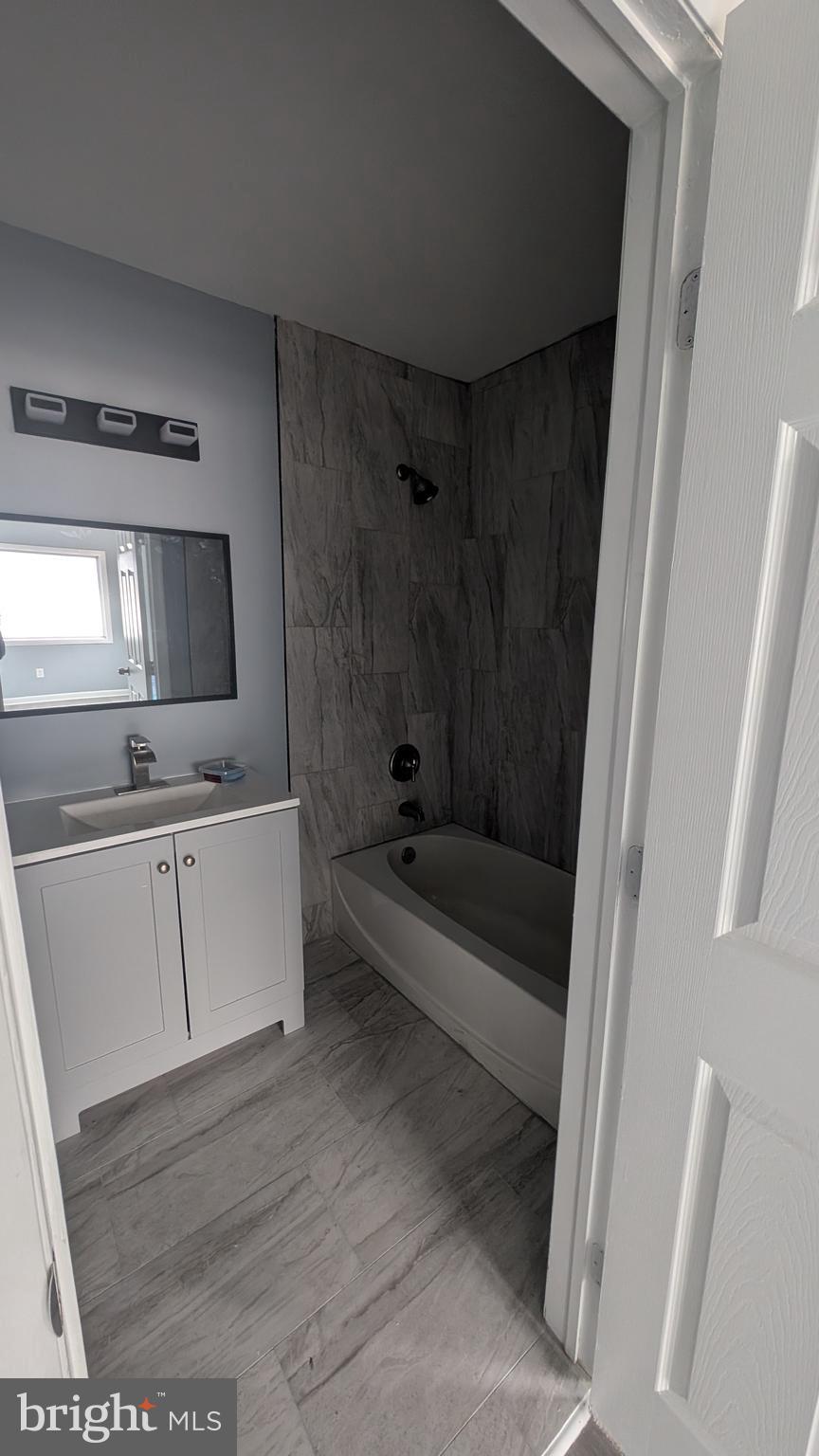 728 Aston Martin Drive Lindenwold, NJ 08021 - Photo 4 of 12 a bathroom with a tub a sink a mirror and a shower