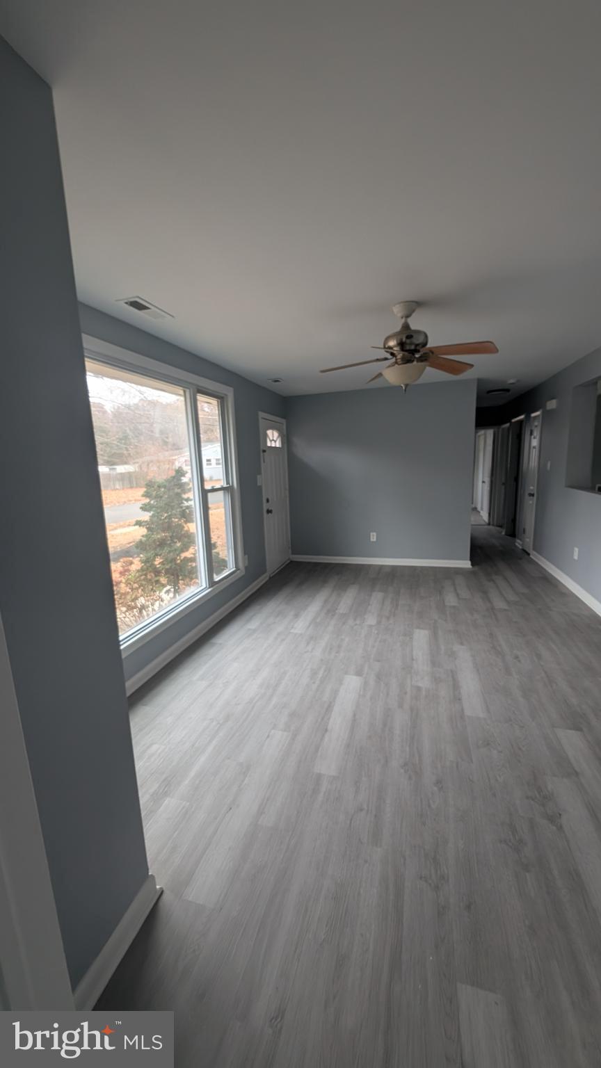 728 Aston Martin Drive Lindenwold, NJ 08021 - Photo 5 of 12 an empty room with wooden floor and windows