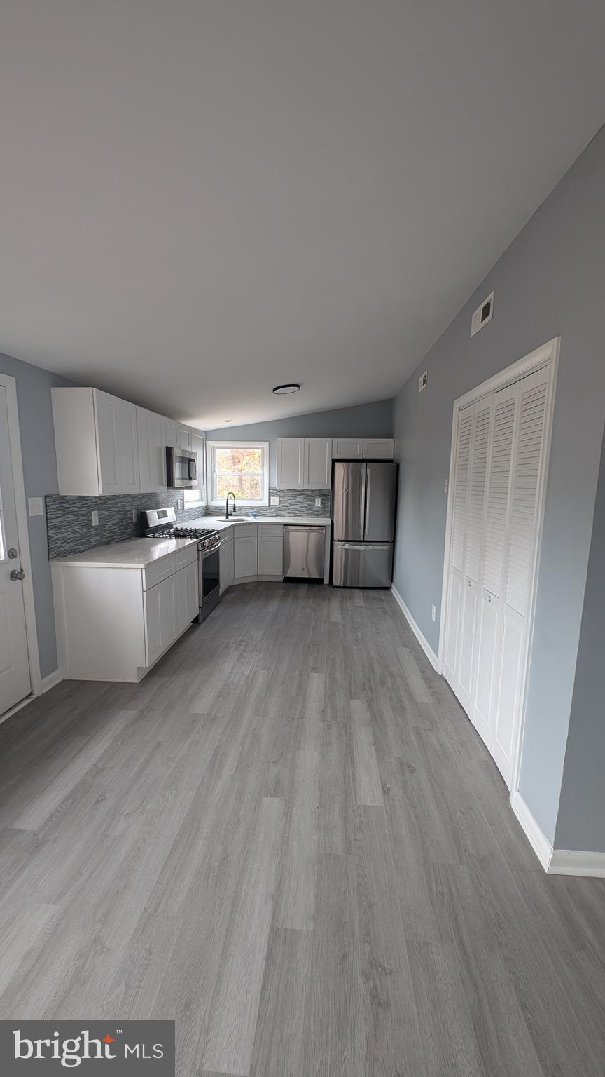 728 Aston Martin Drive Lindenwold, NJ 08021 - Photo 8 of 12 a view of a kitchen with a sink stove cabinets and empty room