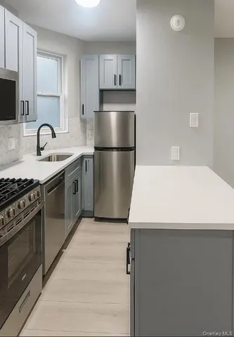 a kitchen with a sink a stove and refrigerator