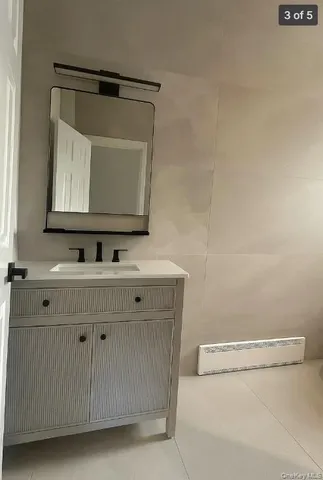 a bathroom with a sink a toilet and mirror