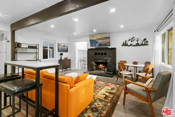 a living room with fireplace furniture and a flat screen tv