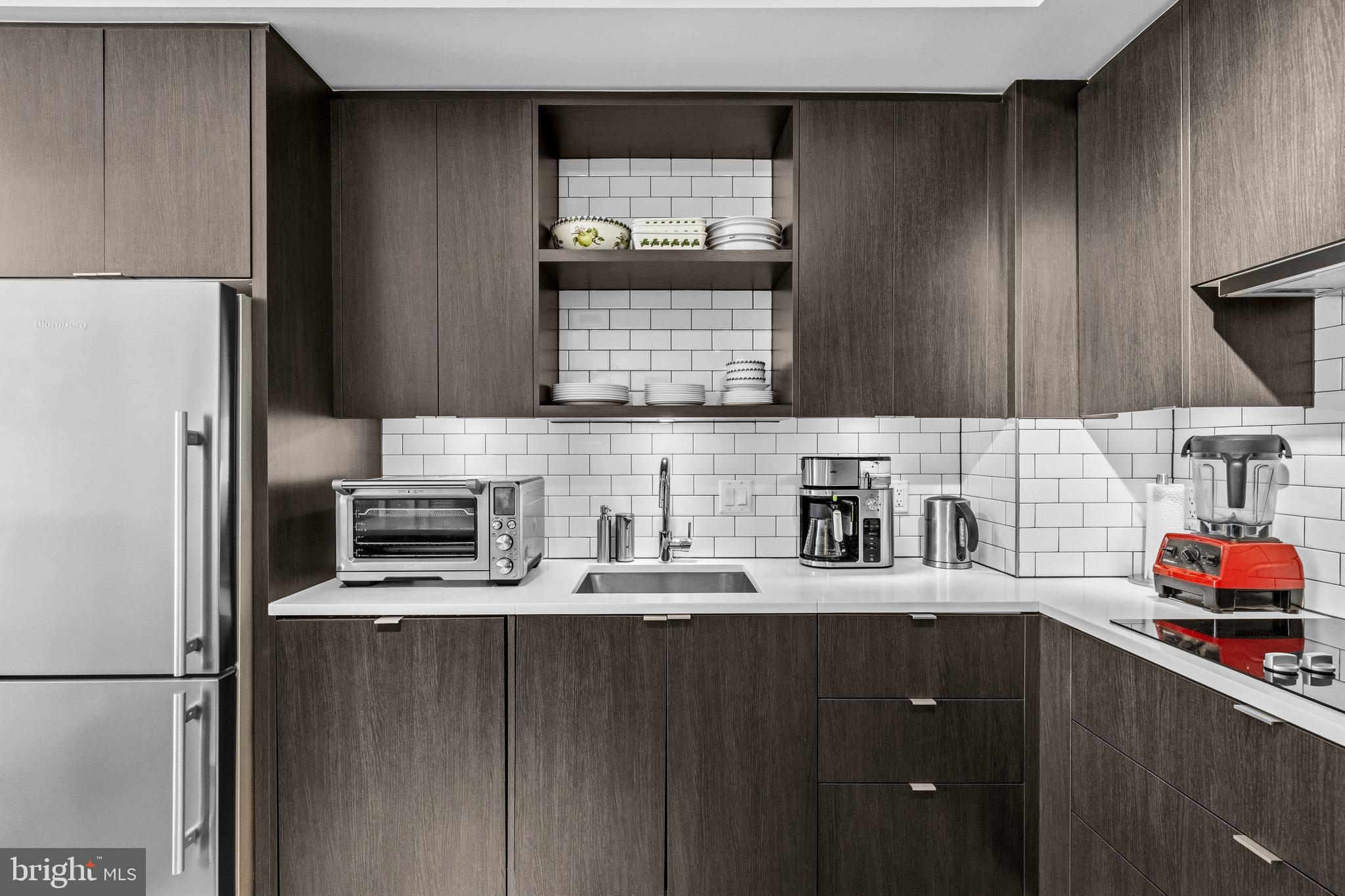 1300 4th Street Southeast, Unit 303 Washington, DC 20003 - Photo 11 of 42 a kitchen with stainless steel appliances granite countertop a refrigerator and sink