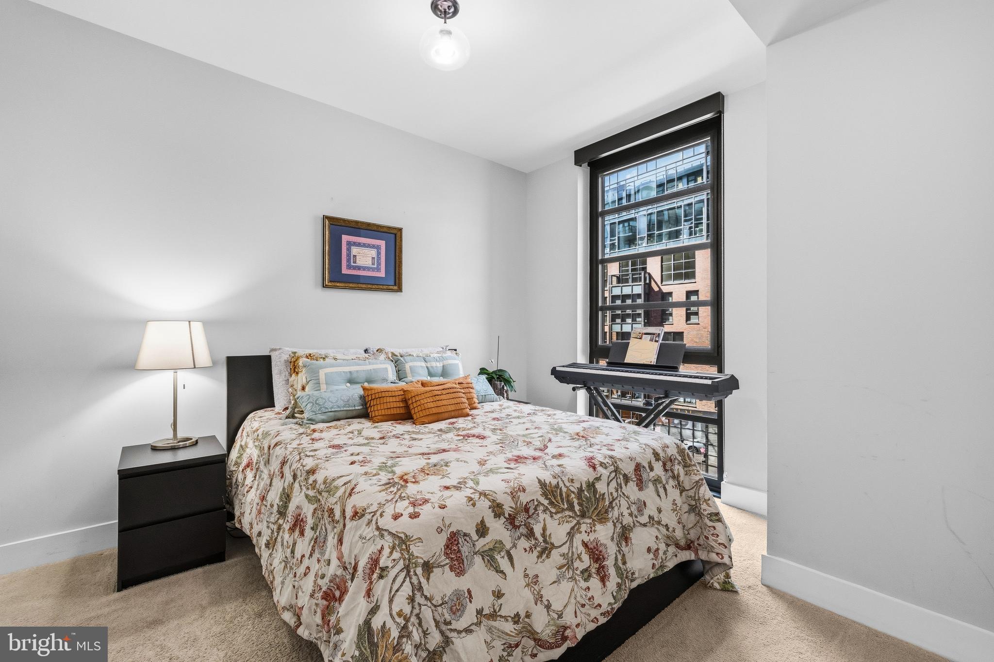 1300 4th Street Southeast, Unit 303 Washington, DC 20003 - Photo 21 of 42 a bedroom with a bed and a window