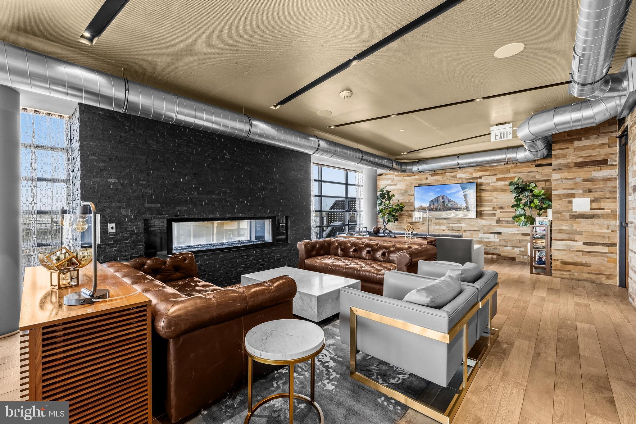 1300 4th Street Southeast, Unit 303 Washington, DC 20003 - Photo 37 of 42 a living room with fireplace furniture and a wooden floor