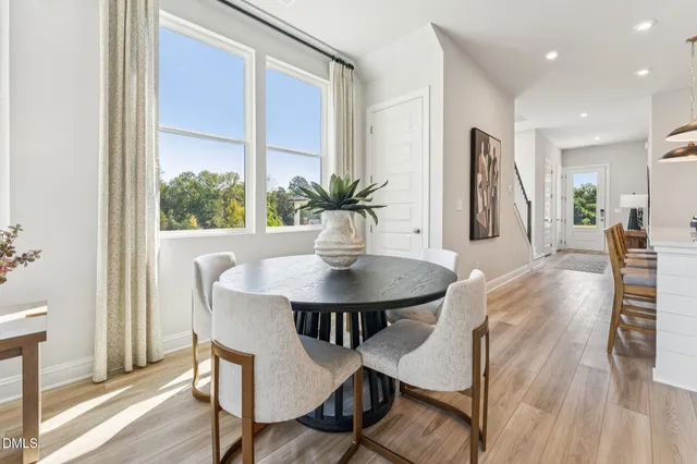 a dining room with furniture and wooden floor