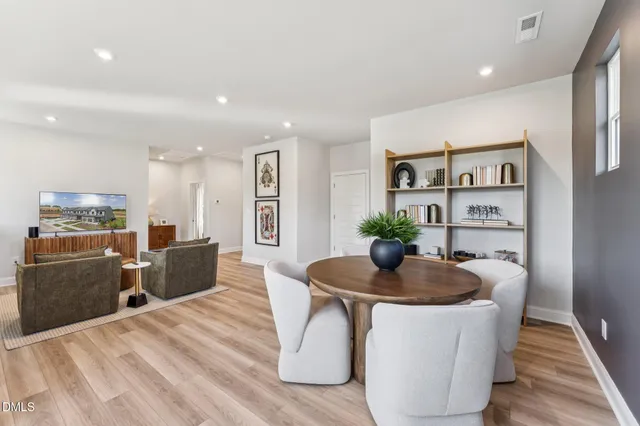 a dining room with furniture and wooden floor