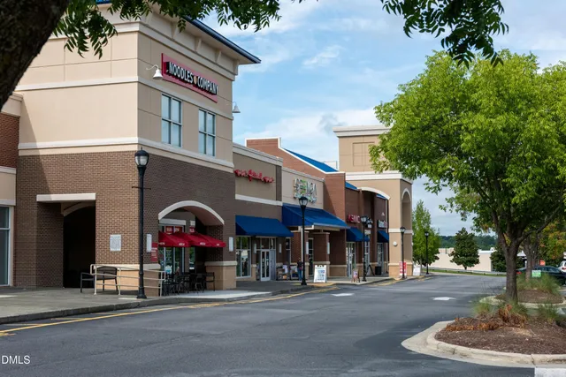 a view of path along with retail shop and building