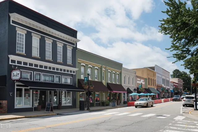a view of a brick building with a bench in front of building