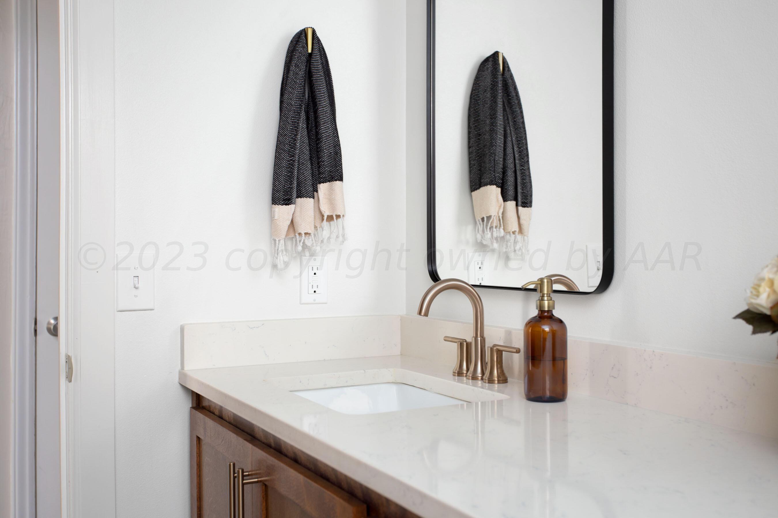 6302 Calumet Road Amarillo, TX 79106 - Photo 20 of 33 a bathroom with a sink and a mirror