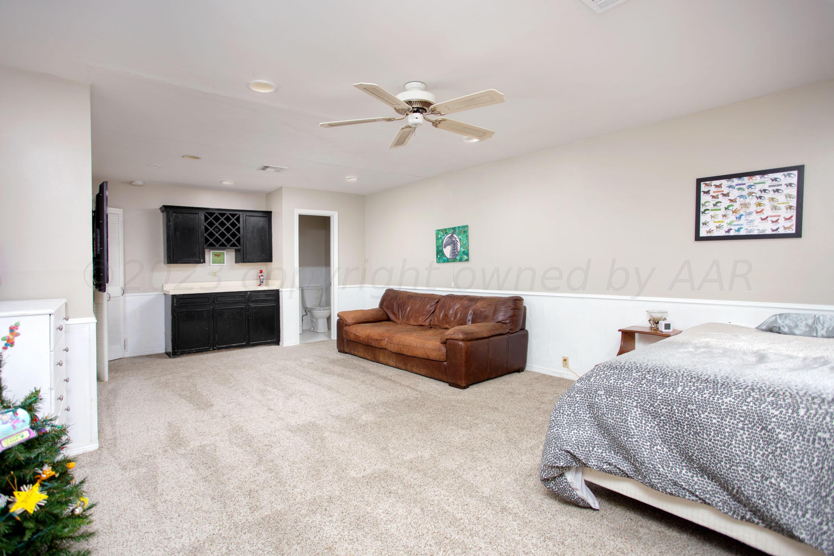 6302 Calumet Road Amarillo, TX 79106 - Photo 25 of 33 a bedroom with a bed and a chandelier