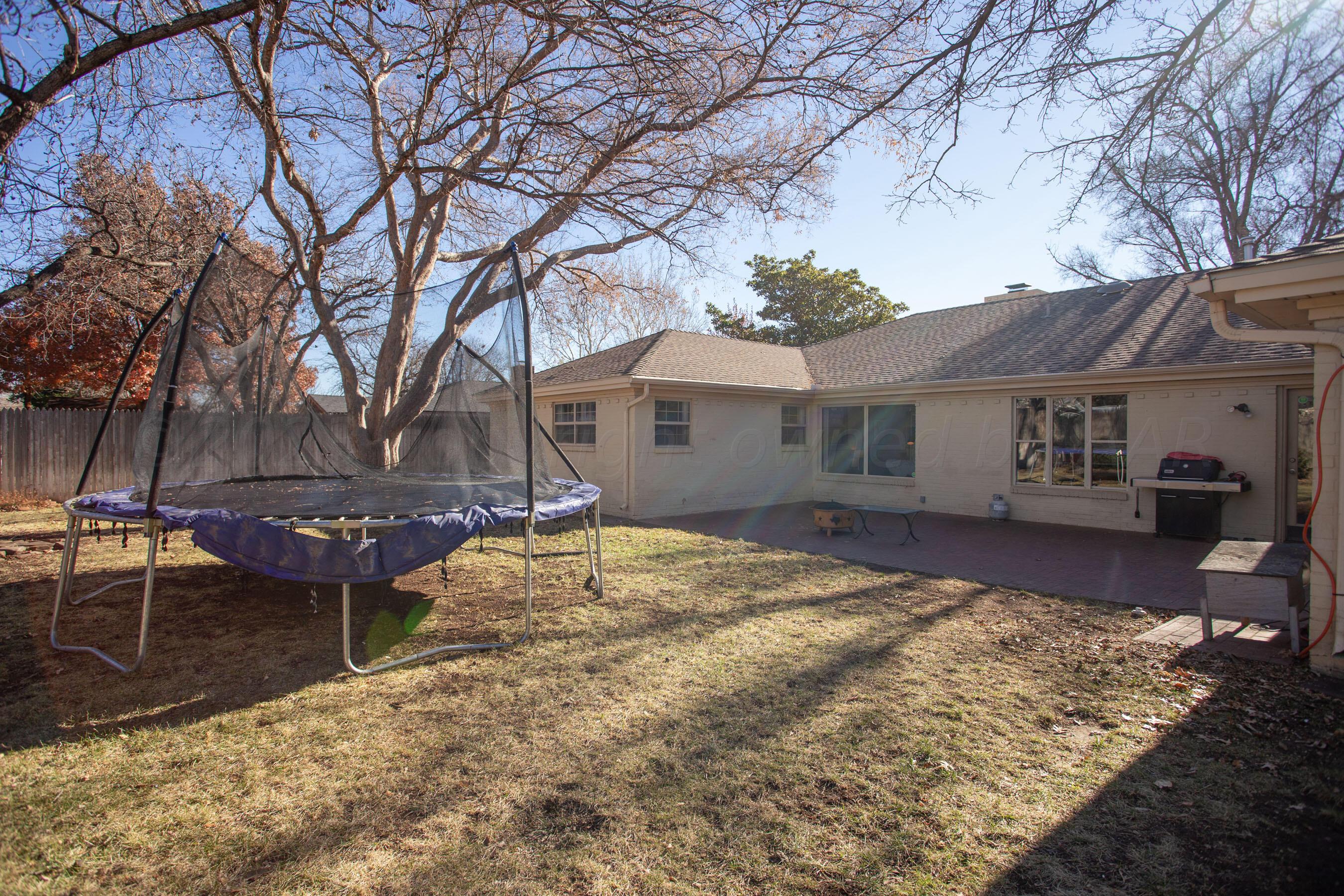6302 Calumet Road Amarillo, TX 79106 - Photo 33 of 33 a view of a house with backyard and a tree