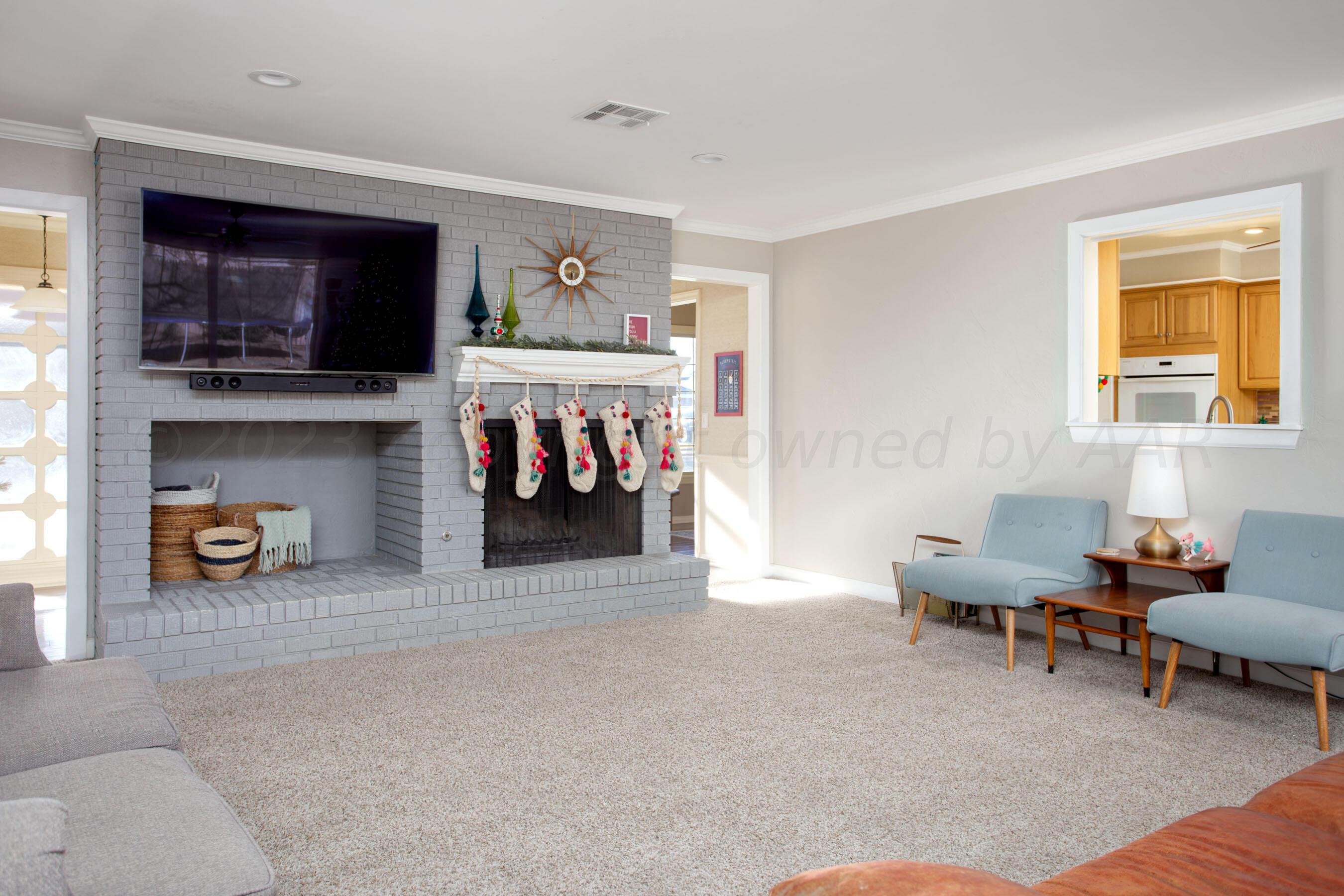 6302 Calumet Road Amarillo, TX 79106 - Photo 6 of 33 a living room with furniture and a flat screen tv