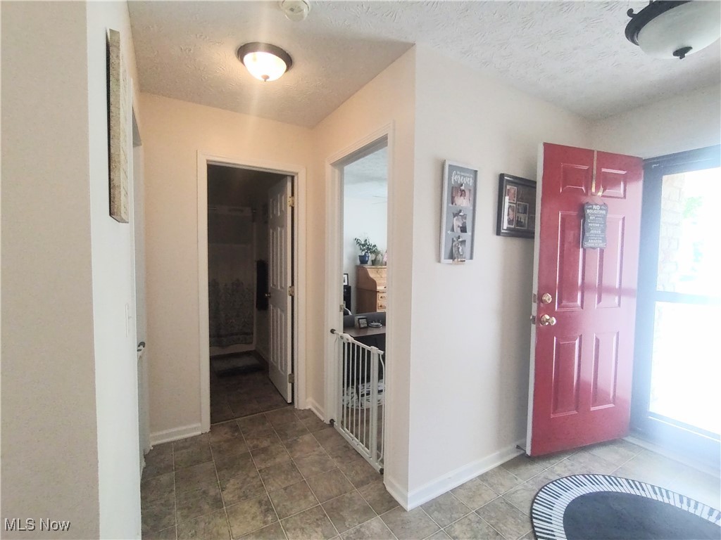 870 Susan Road Ravenna, OH 44266 - Photo 7 of 35 Foyer entrance with a textured ceiling and baseboards