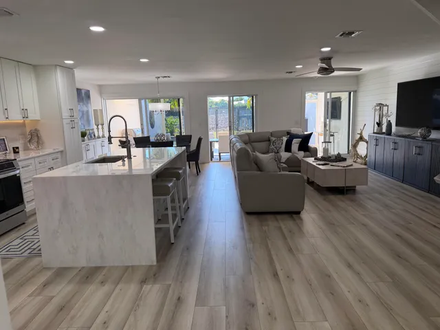 a living room with fireplace furniture and a floor to ceiling window