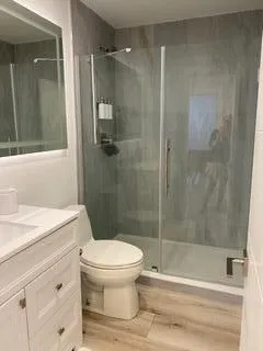 a view of a patio with a dining table and chairs with wooden floor