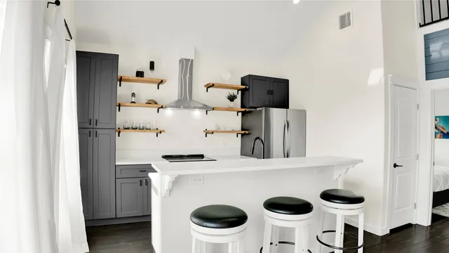 a room with cabinets and white appliances