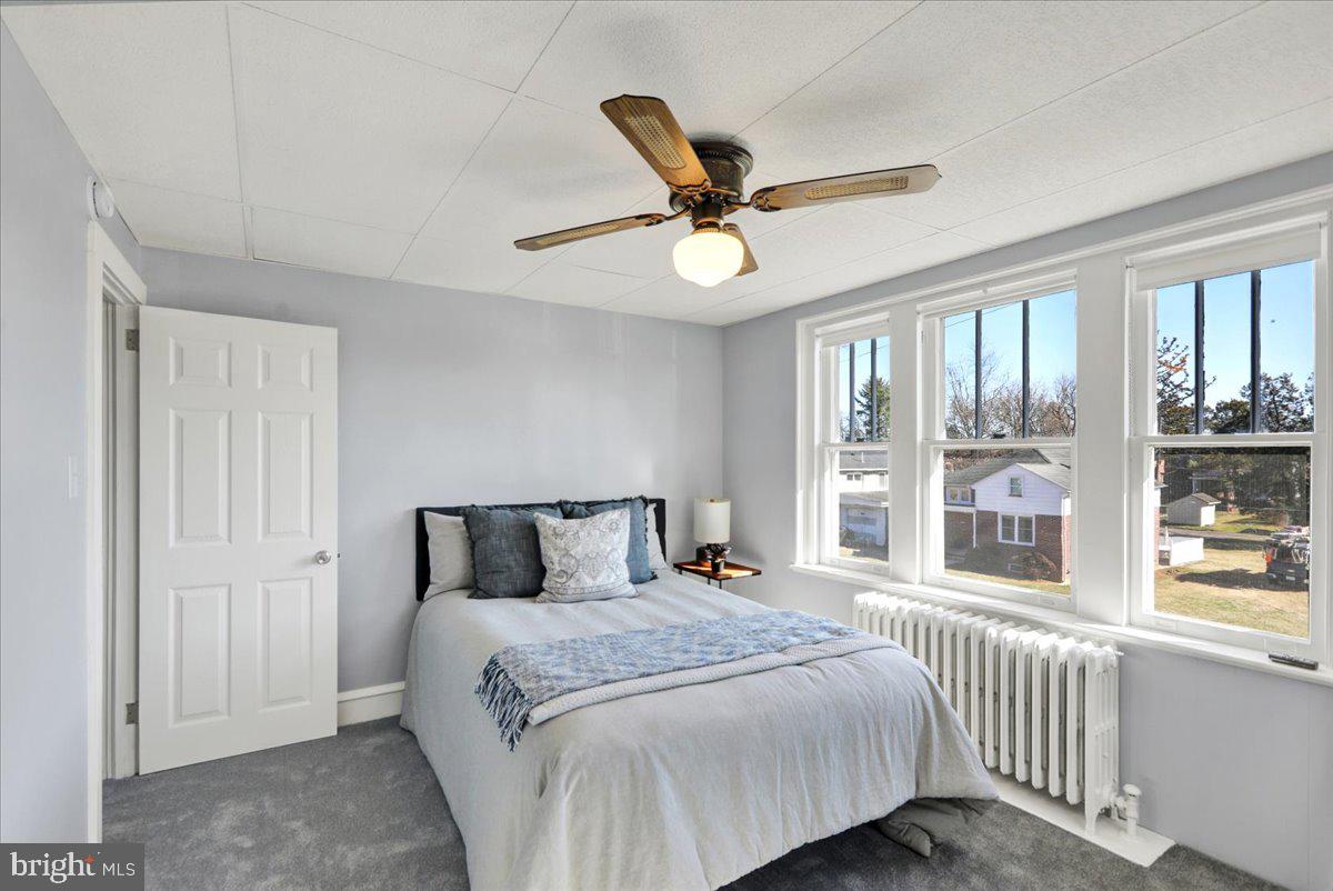 2133 Fairview Street Reading, PA 19609 - Photo 14 of 34 a bedroom with a large bed and a large window with the outer view