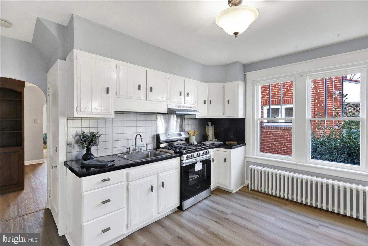 2133 Fairview Street Reading, PA 19609 - Photo 9 of 34 a kitchen with stainless steel appliances granite countertop a stove a sink and white cabinets