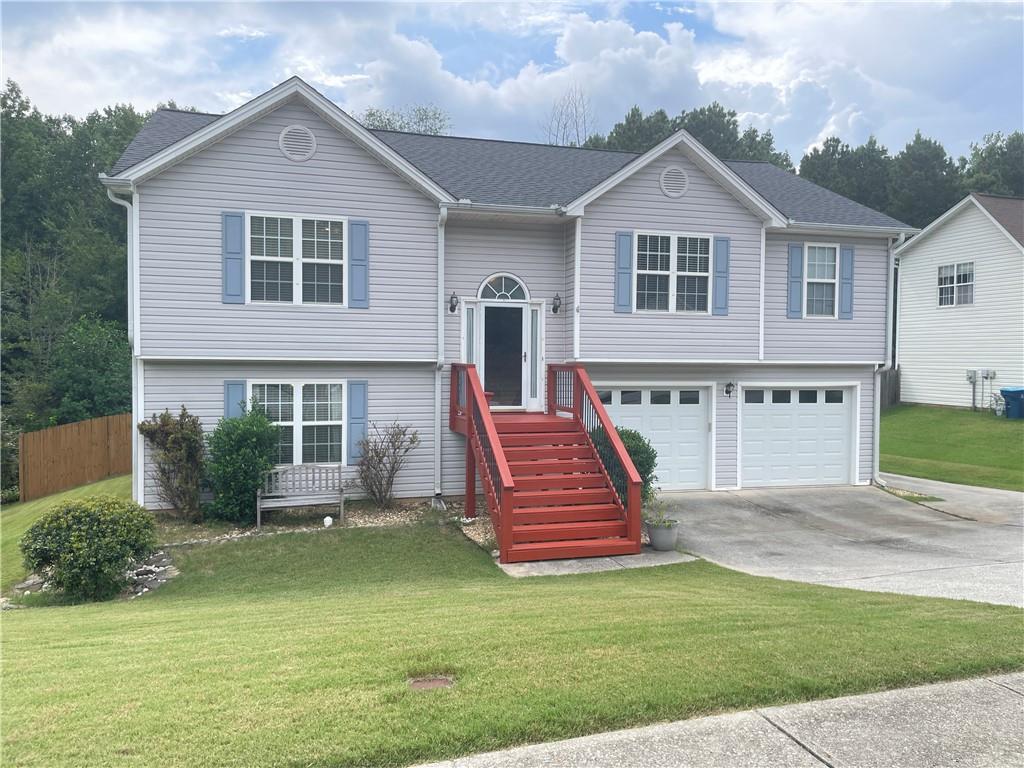 a front view of a house with a garden and plants