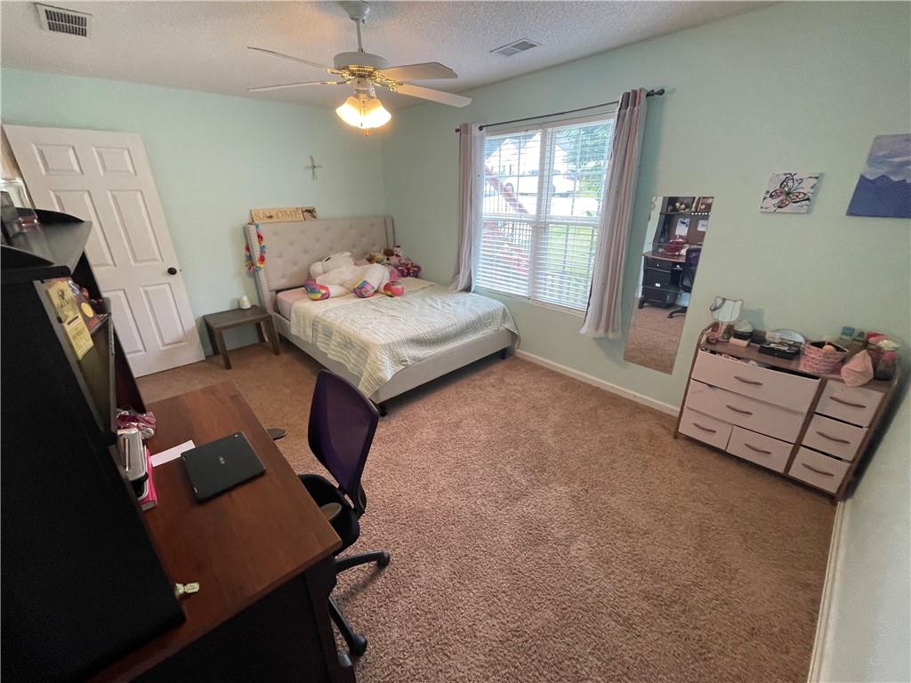 1720 Fort Daniels Trail Dacula, GA 30019 - Photo 11 of 32 a bedroom with furniture and a window