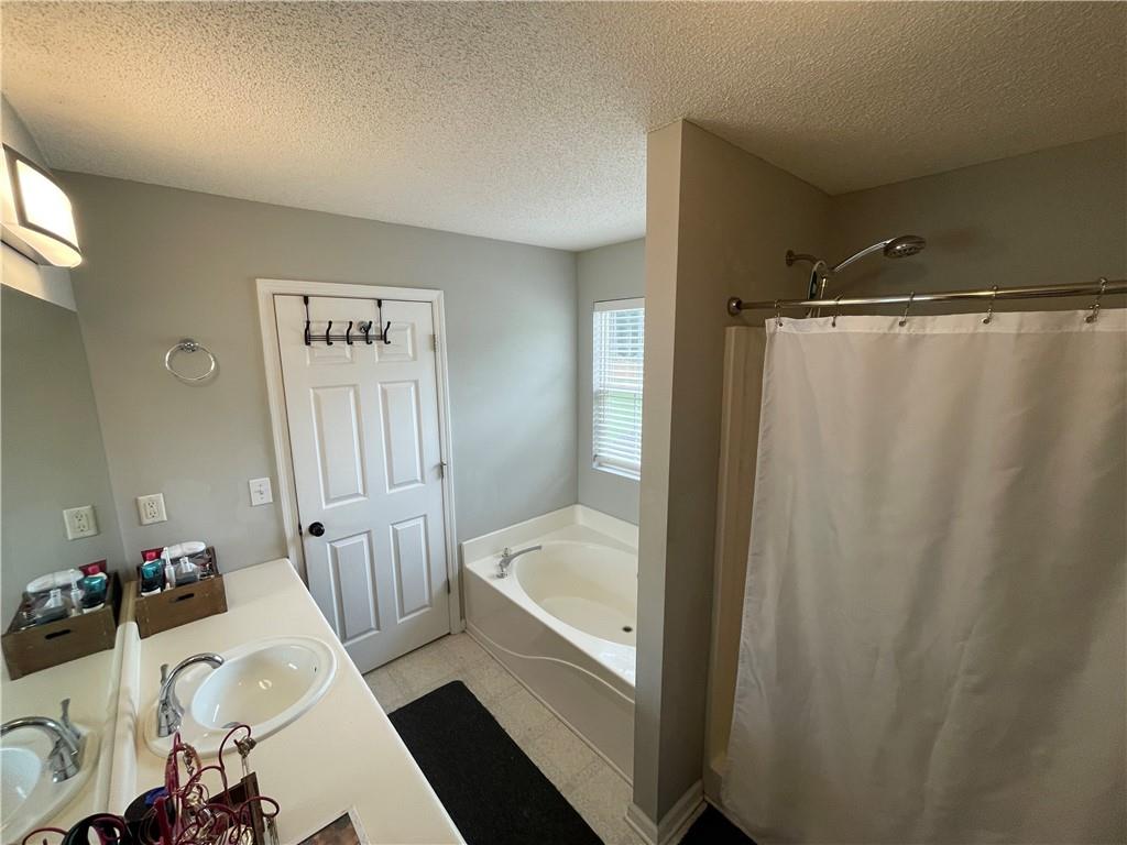 1720 Fort Daniels Trail Dacula, GA 30019 - Photo 15 of 32 a bathroom with a sink and a shower