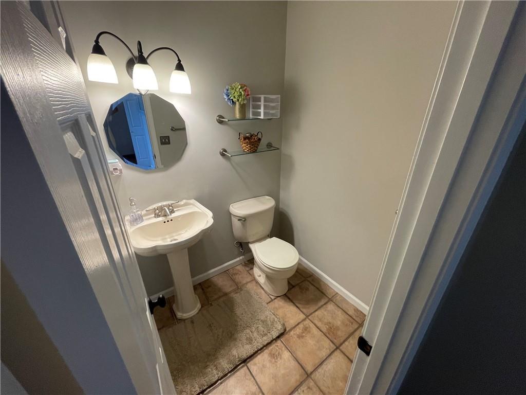 1720 Fort Daniels Trail Dacula, GA 30019 - Photo 17 of 32 a bathroom with a toilet mirror and sink