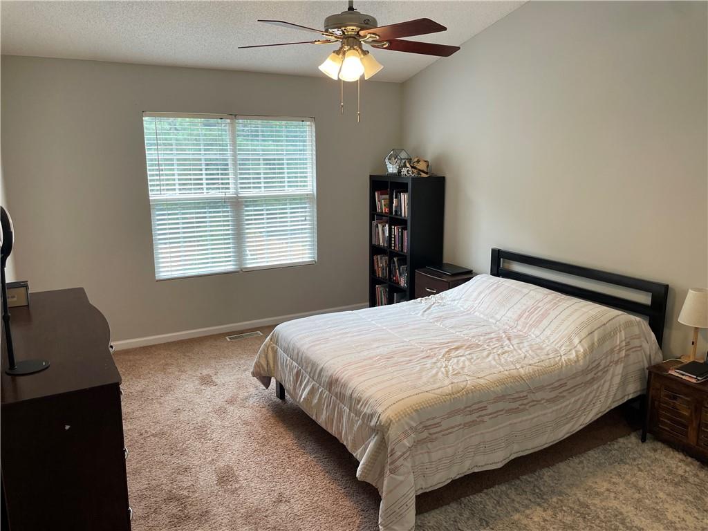 1720 Fort Daniels Trail Dacula, GA 30019 - Photo 20 of 32 a bedroom with a bed and a window