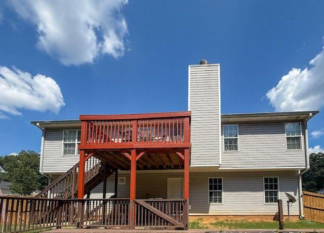 1720 Fort Daniels Trail Dacula, GA 30019 - Photo 2 of 32 a view of a roof deck with table and chairs