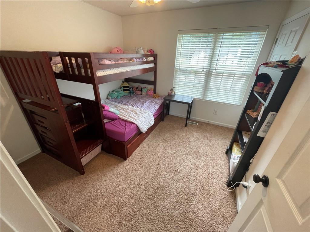 1720 Fort Daniels Trail Dacula, GA 30019 - Photo 23 of 32 a bedroom with furniture and a window