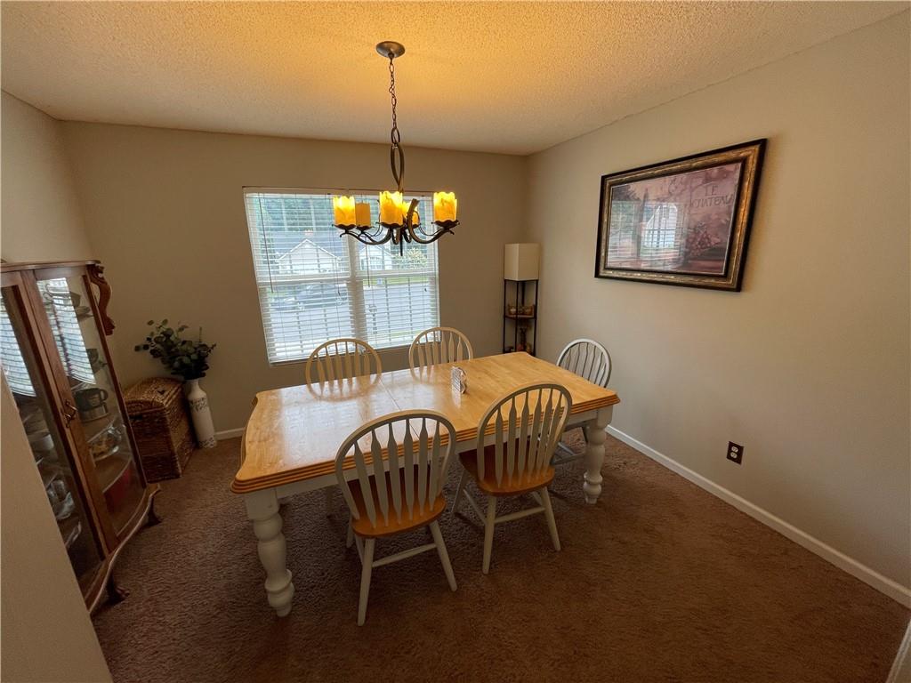 1720 Fort Daniels Trail Dacula, GA 30019 - Photo 26 of 32 a dining room with furniture and window