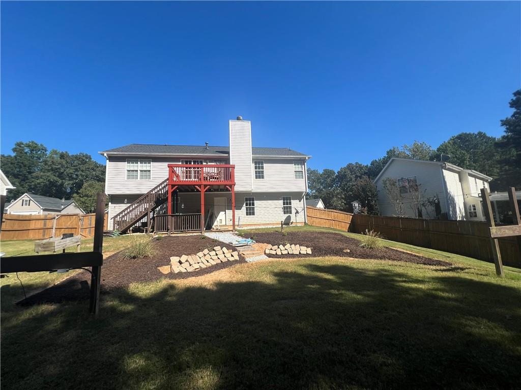 1720 Fort Daniels Trail Dacula, GA 30019 - Photo 31 of 32 a view of a house with backyard and a garden