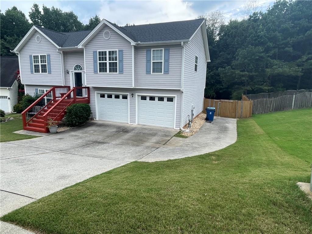 1720 Fort Daniels Trail Dacula, GA 30019 - Photo 4 of 32 a view of a house with backyard and sitting area