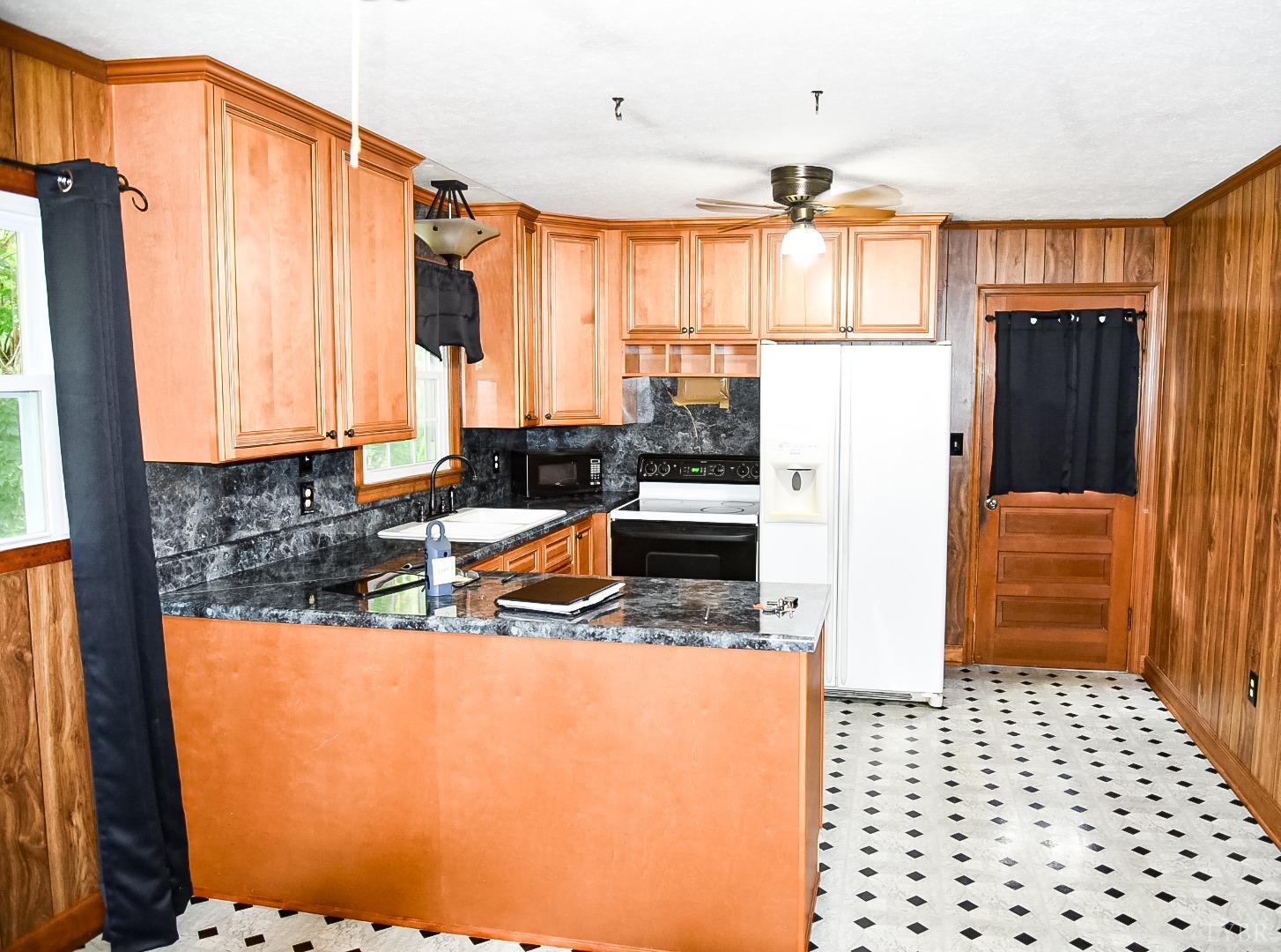 243 West Spencer Road Hurt, VA 24563 - Photo 5 of 28 a kitchen with stainless steel appliances a refrigerator sink and cabinets