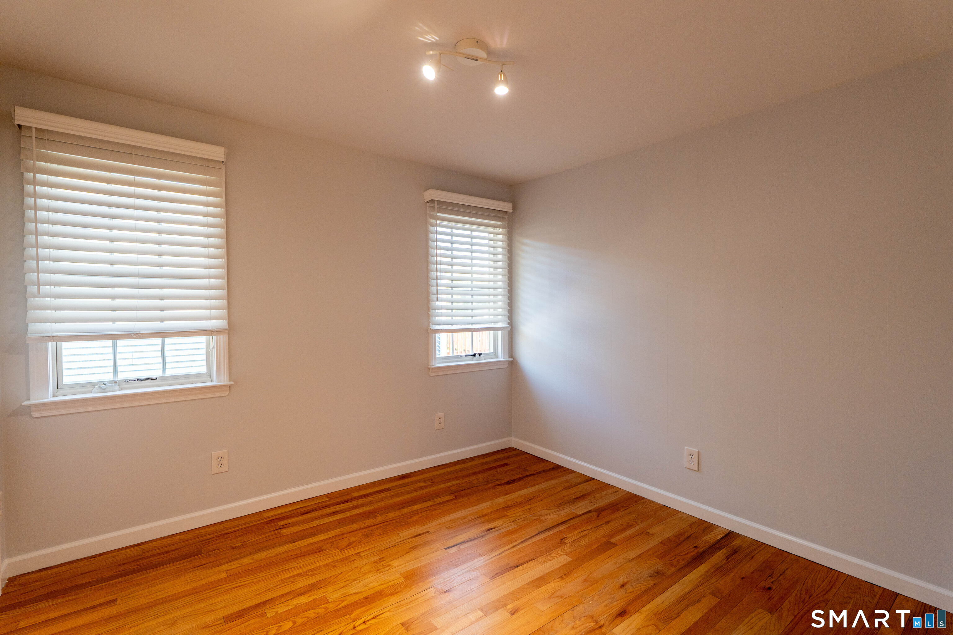 19 Elaine Road Milford, CT 06460 - Photo 14 of 24 a view of empty room with wooden floor and fan