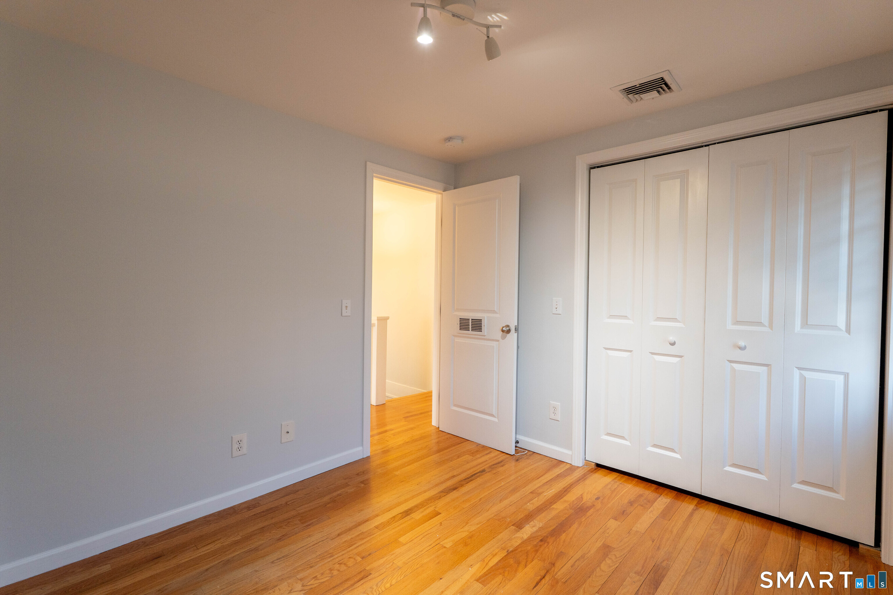 19 Elaine Road Milford, CT 06460 - Photo 16 of 24 a view of an empty room and wooden floor